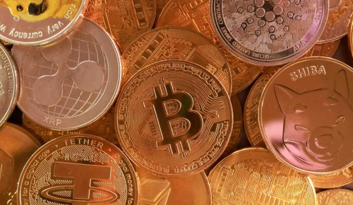 Close-up of a pile of shiny cryptocurrency coins, dominated by Bitcoin logos (BTC) and other crypto symbols like Ethereum and Ripple.