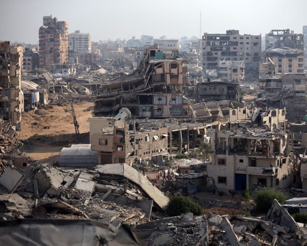 Post-war urban landscape with collapsed buildings, rubble, and dusty streets filling a wide city view.