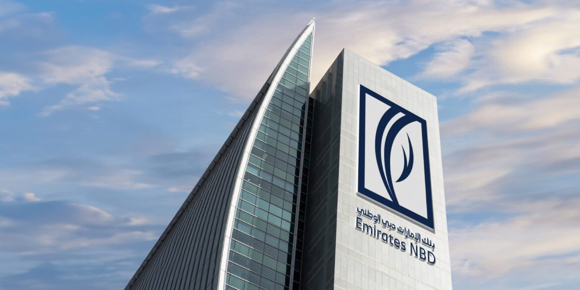 Modern skyscraper featuring the Emirates NBD logo on a light-gray facade against a blue sky.