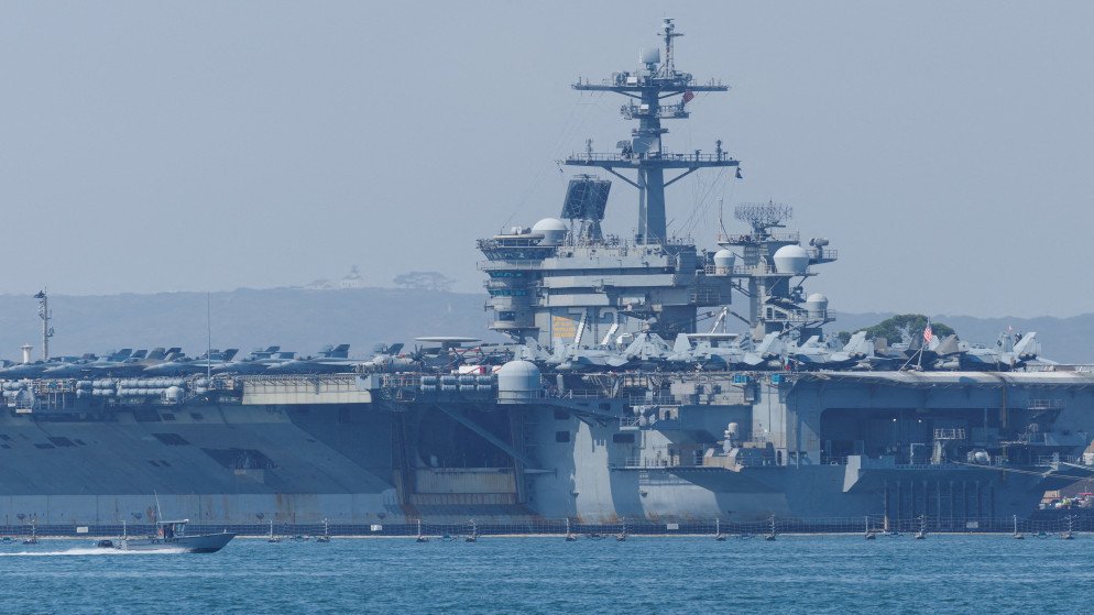 Us Navy Aircraft Carrier Docked at a Harbor with Fighter Jets Lined on the Flight Deck  Aleumumnews