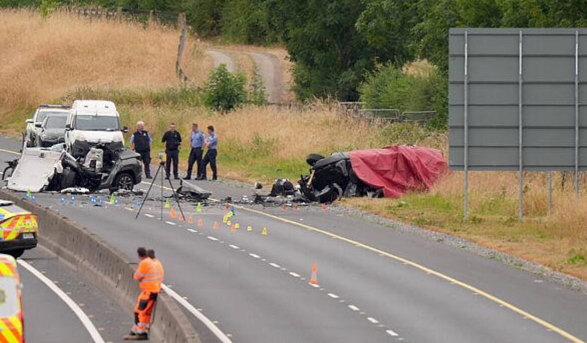 Multiple damaged vehicles on a highway shoulder after a crash, with emergency responders and traffic cones marking the scene.