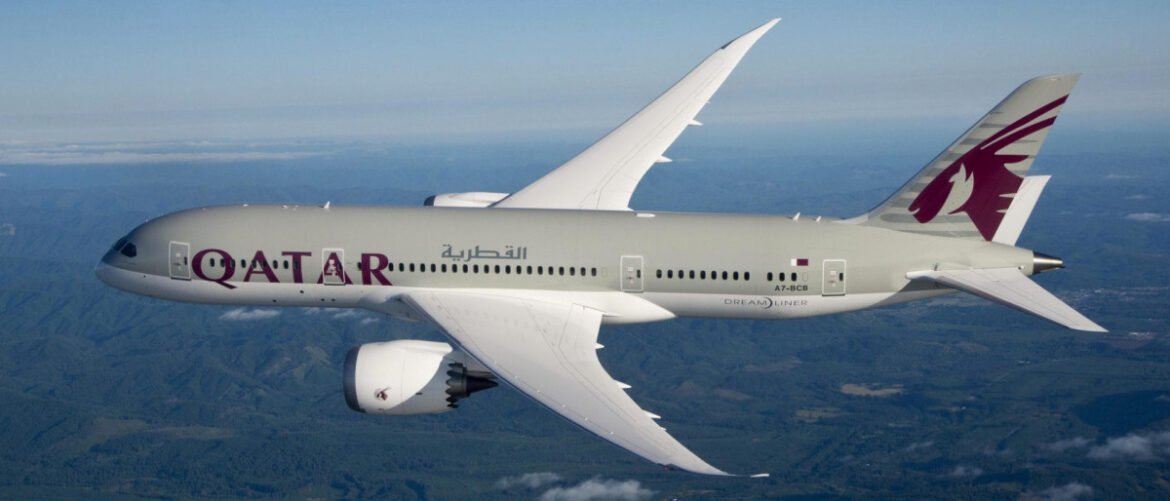 Qatar Airways plane in flight, side view, with purple Oryx tail logo on the tail fin.