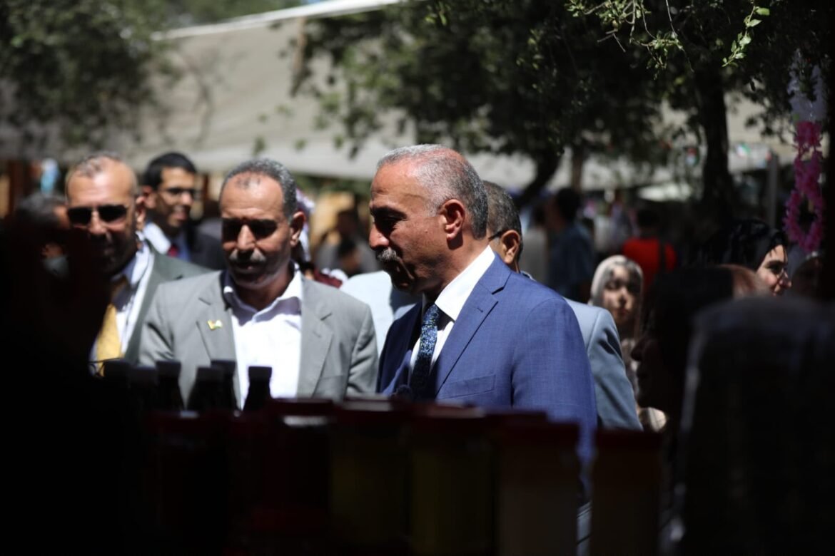 Man in a blue suit stands among a crowd at an outdoor market or event, with others in business attire nearby.