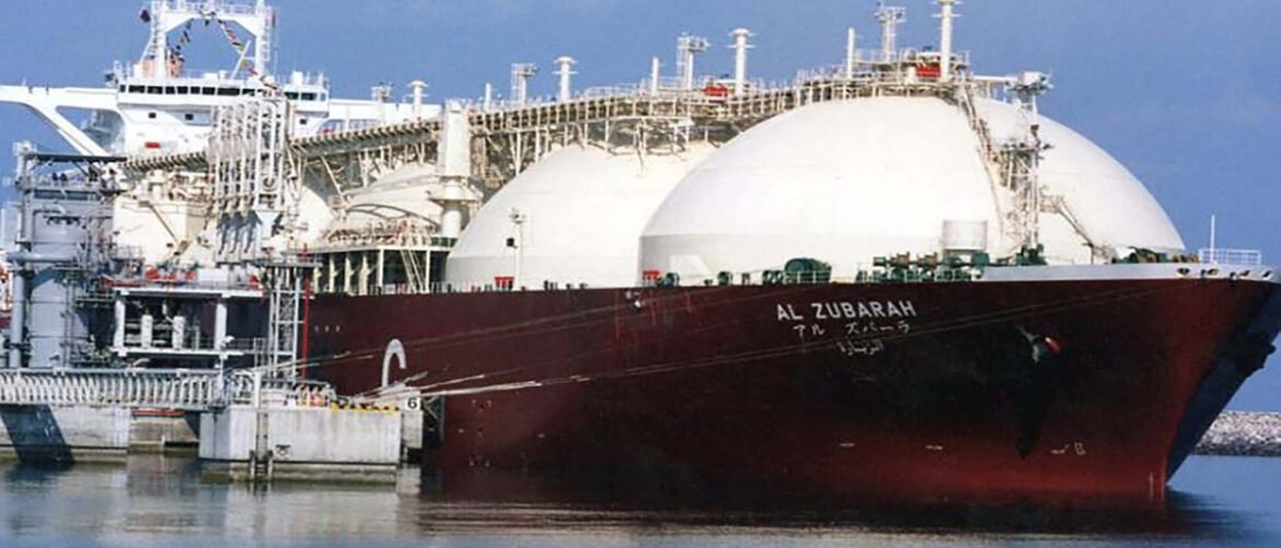Large LNG carrier AL ZUBARAH docked at a port with white spherical storage tanks and loading gantry nearby.