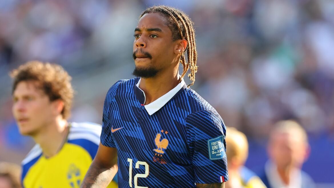 France national footballer wearing blue kit with number 12, on the field during a match.