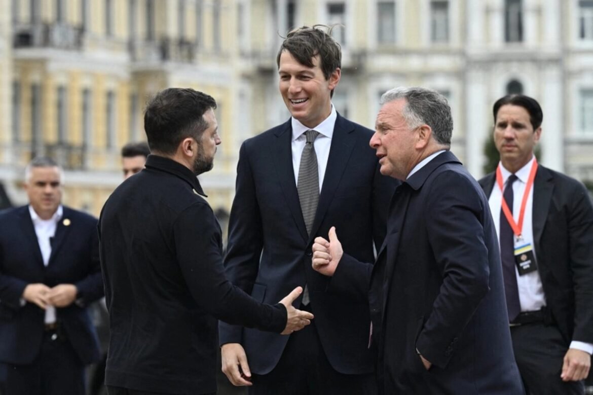 Two men in dark suits shake hands while talking, with a taller man smiling between them, outside a historic building.