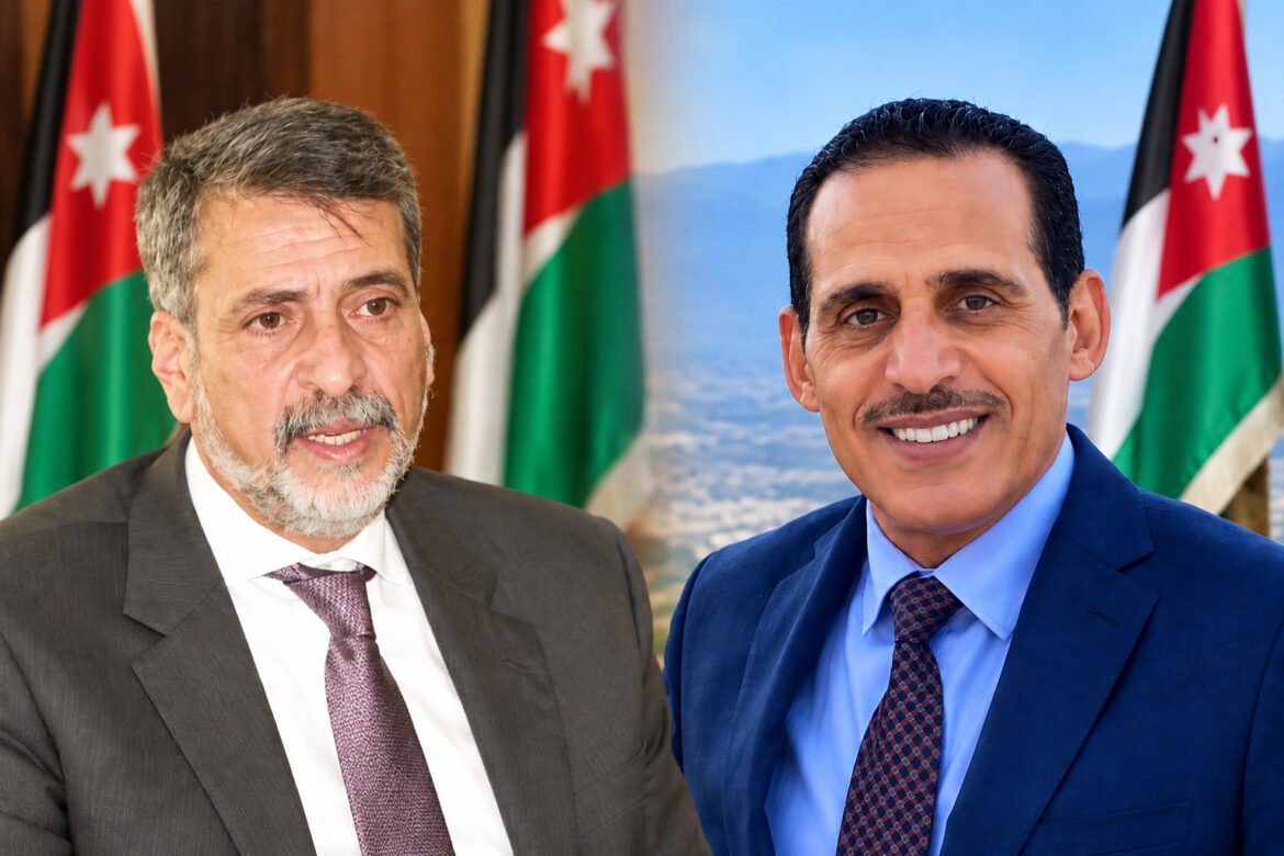 Two men in suits smiling for the camera with Jordanian flags in the background at a formal event.